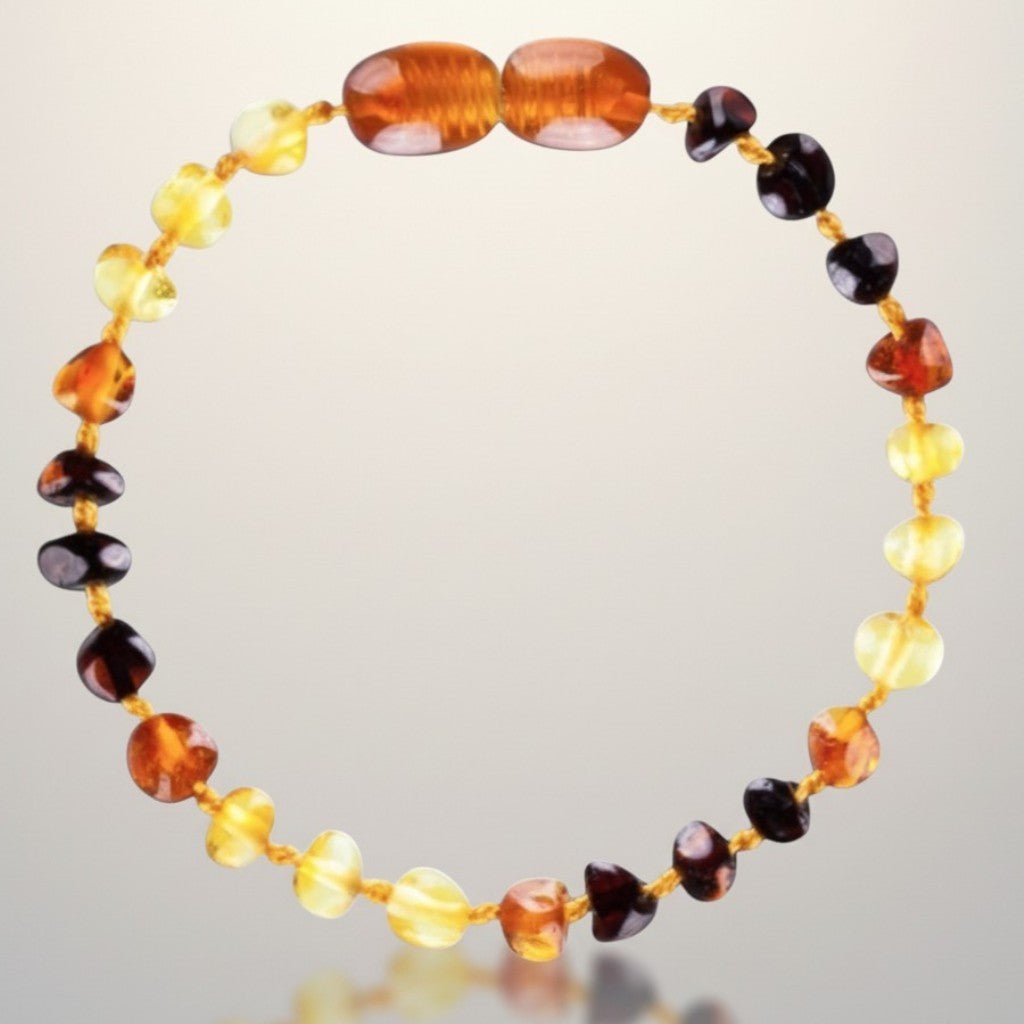 Bracelet bébé ambre multicolore Lituanie AA (perles baroques) - La Boite à Cailloux