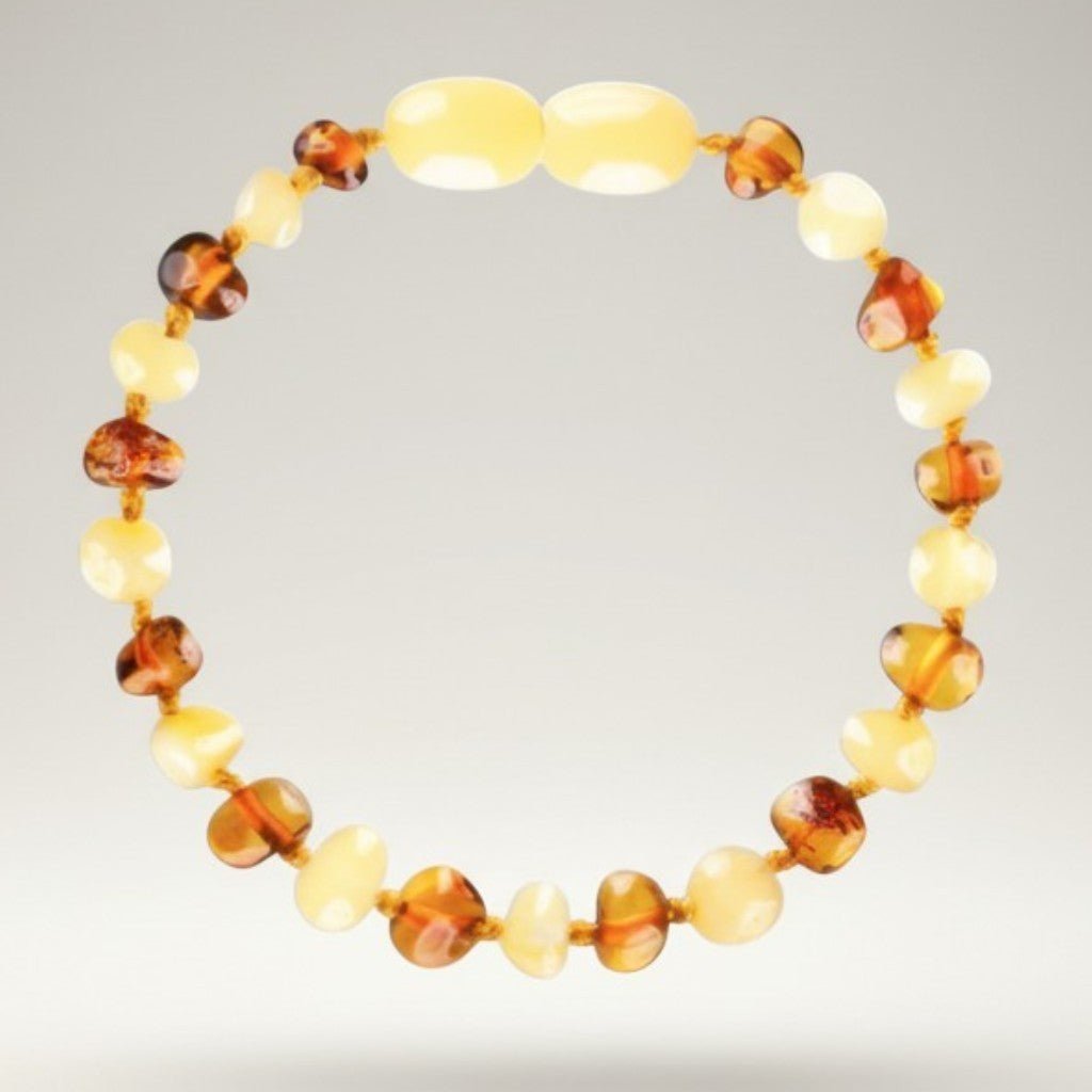 Bracelet bébé bicolore ambre jaune et ambre cognac Lituanie AA (perles baroques) - La Boite à Cailloux