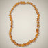 Collier bébé ambre miel Lituanie AA (perles baroques) - La Boite à Cailloux